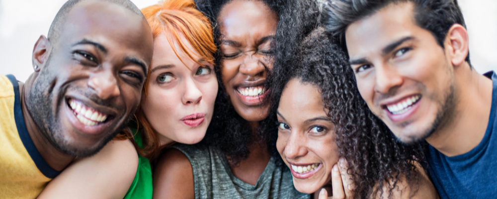 Diverse group of five people smiling