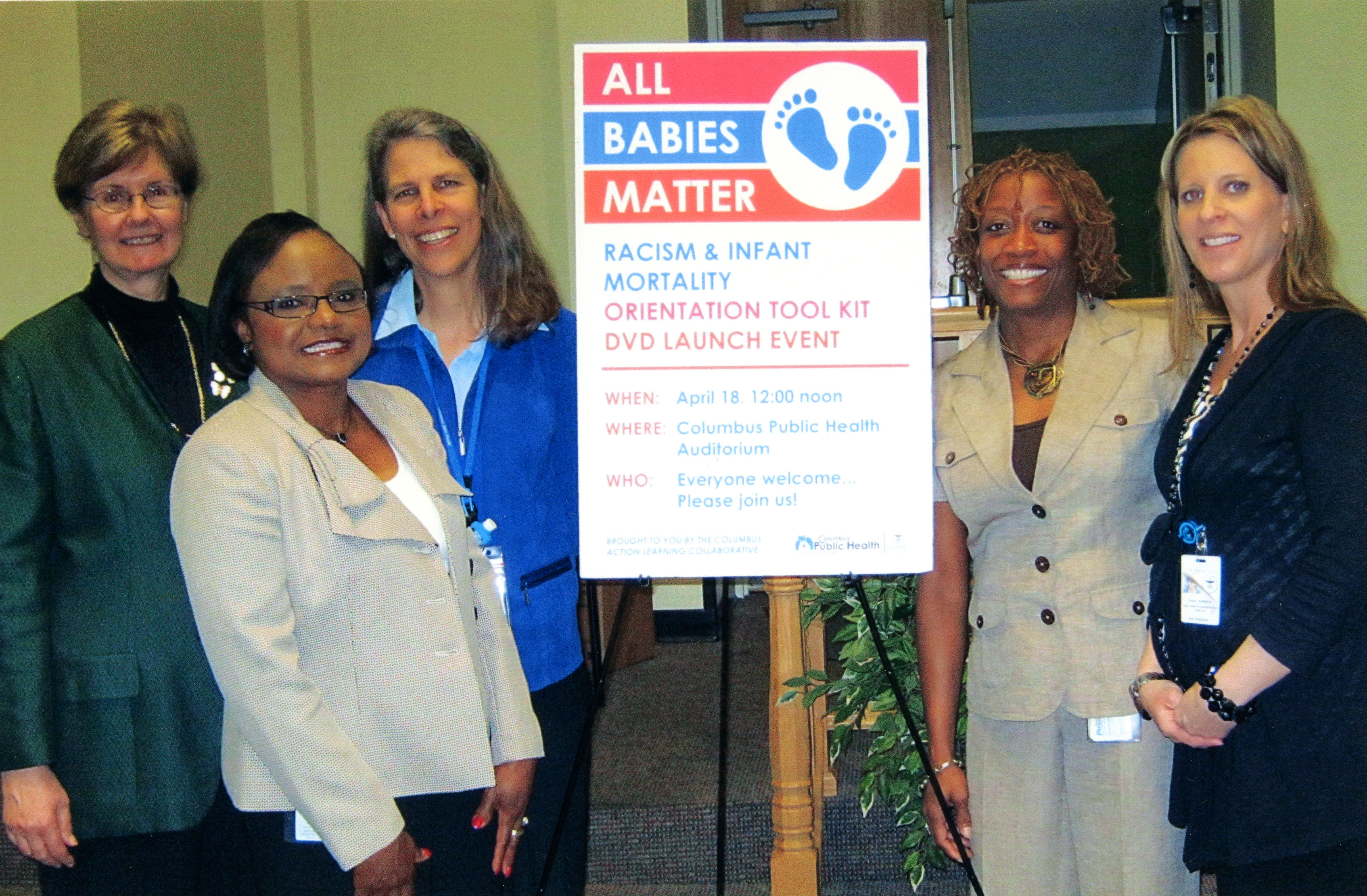 Dr. Long standing next to colleagues