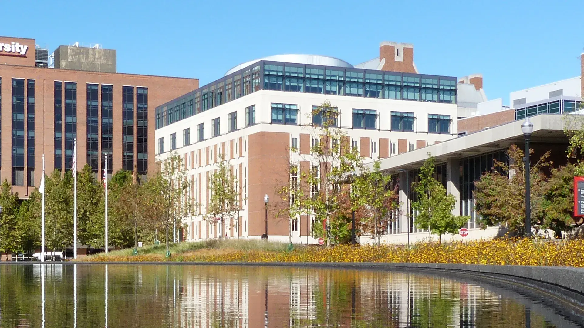 A wide view of Prior Hall and University Hospitals with a fountain in the foreground