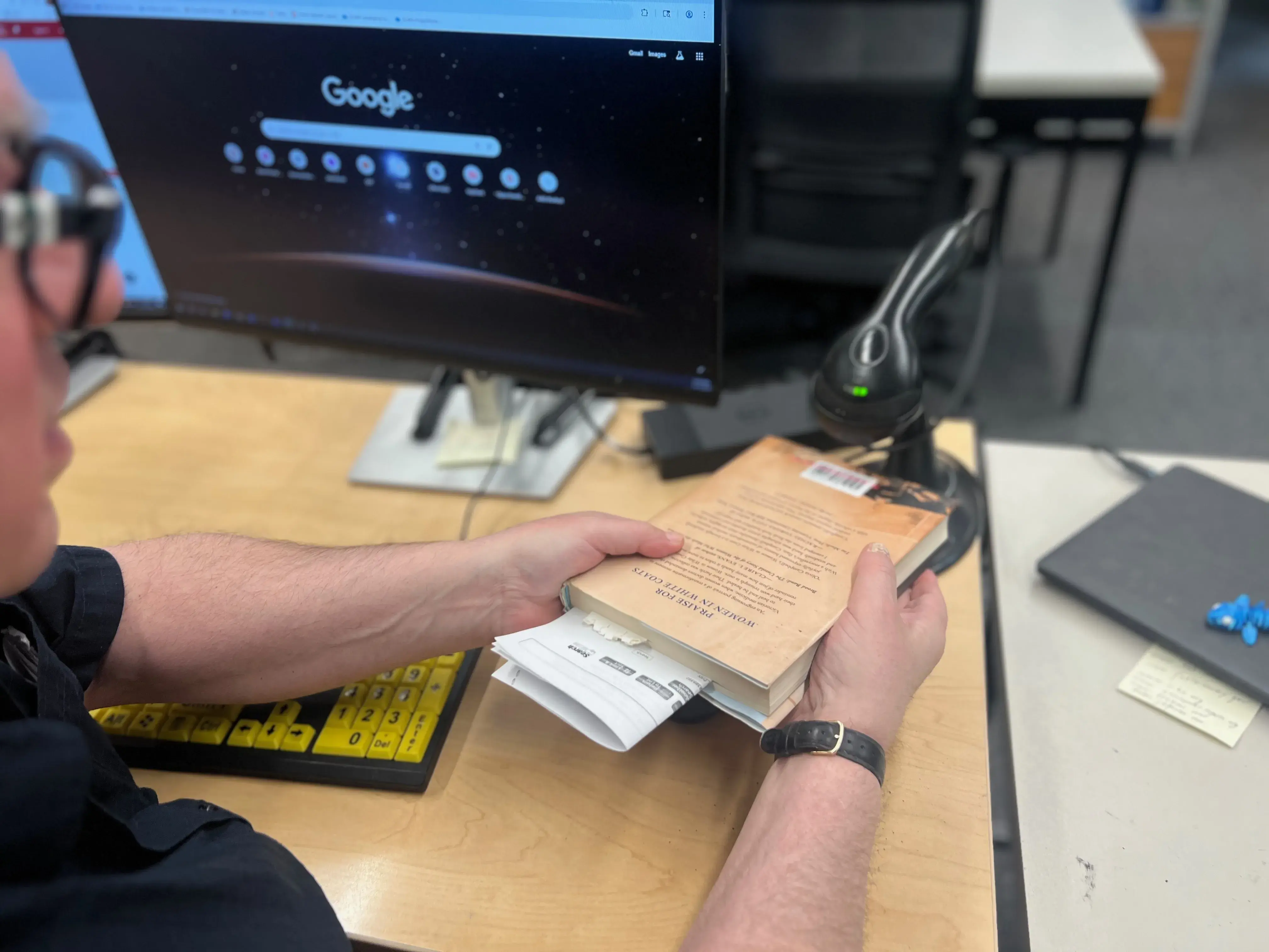A librarian scanning a book's barcode.