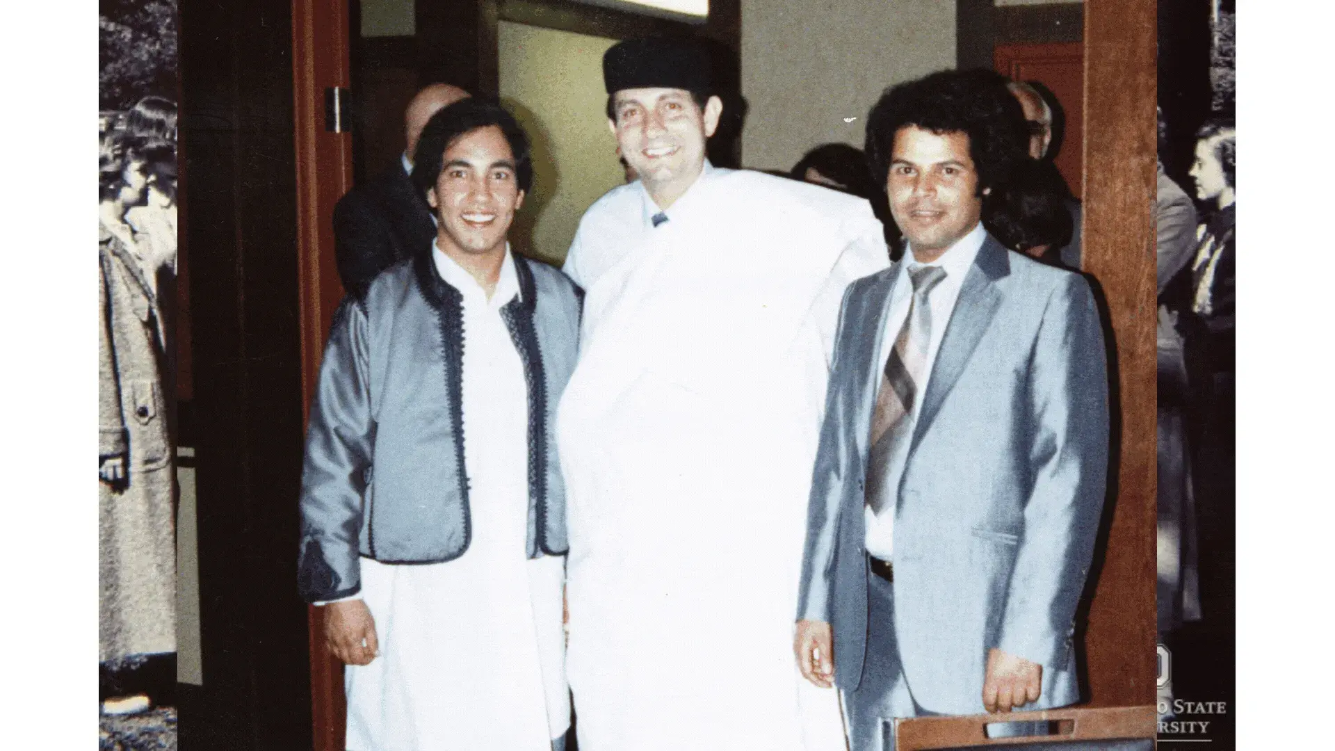 Manuel Tzagournis, smiling while posing with two other men.