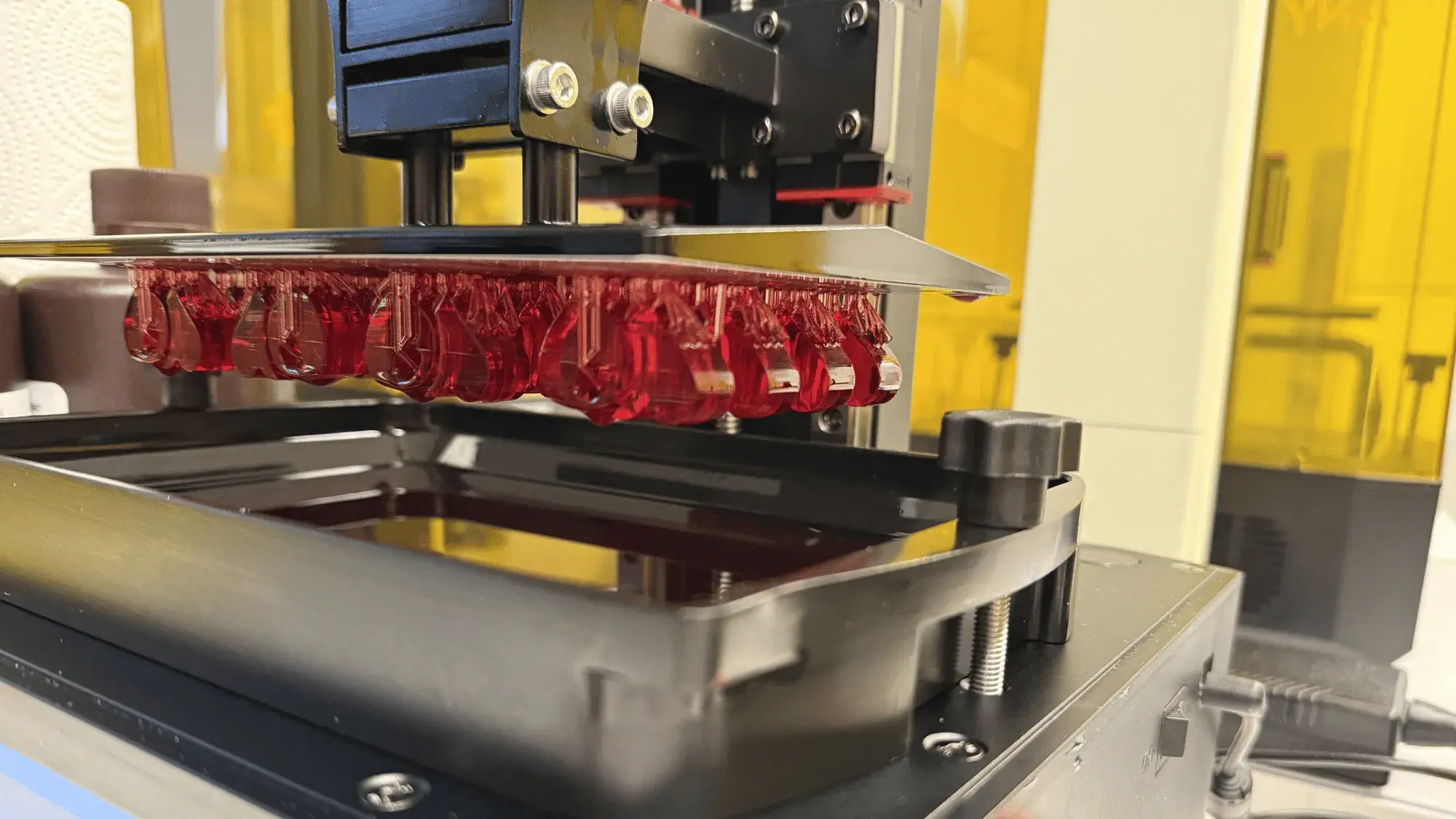 3D prints are suspended on a 3D printer build plate