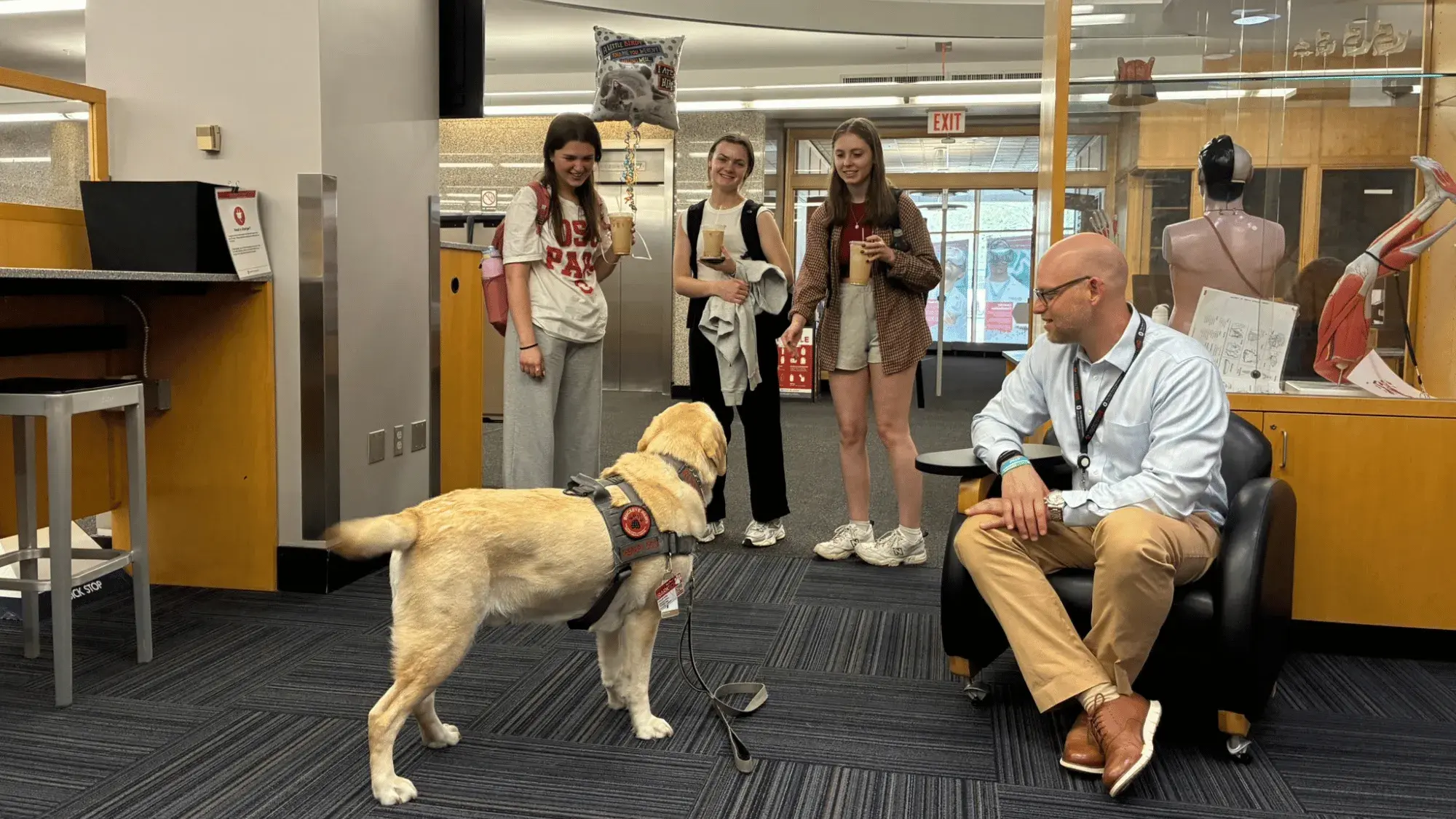 Students visiting with Buckeye Paws dog Russell
