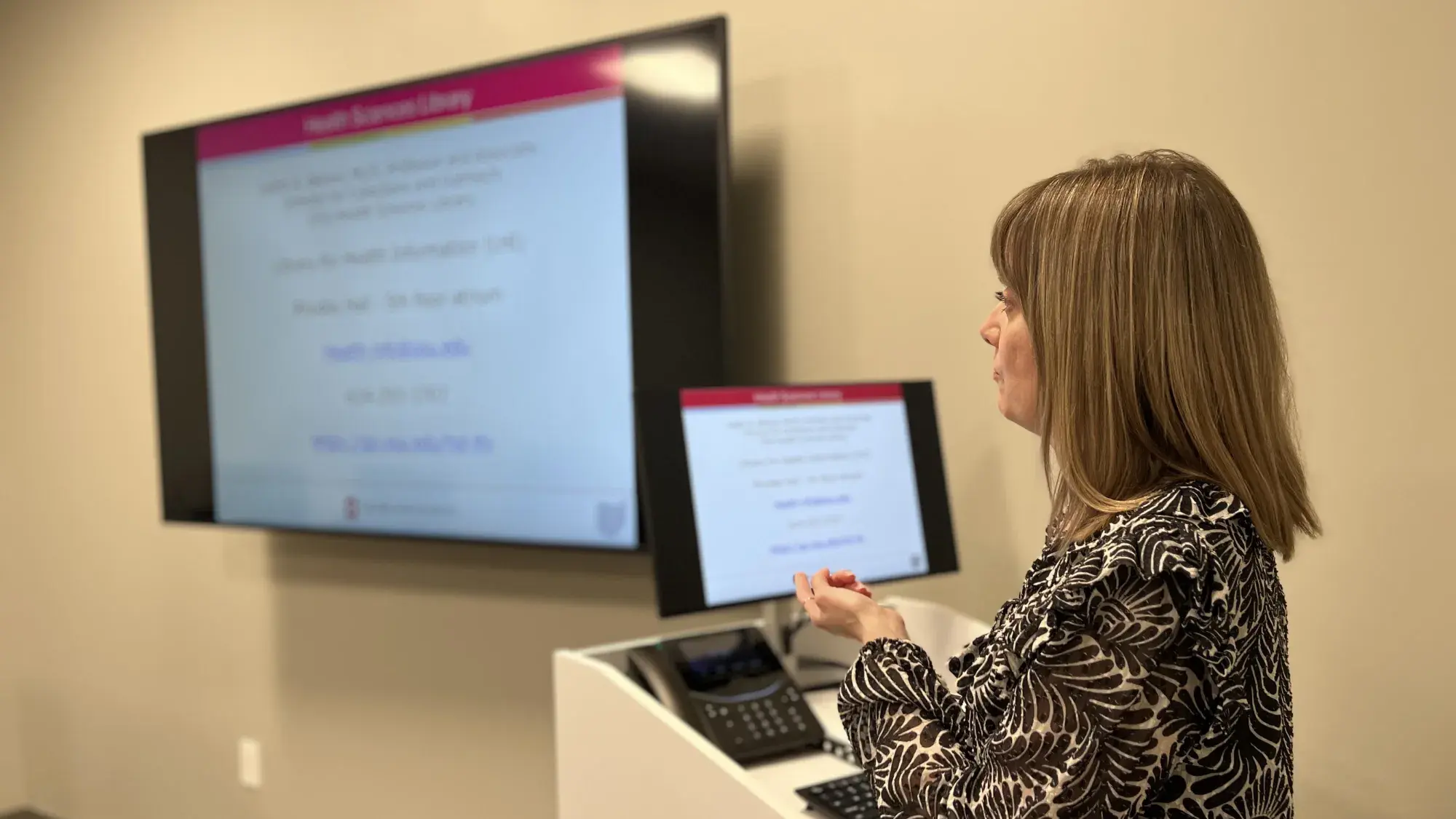 Woman presenting an Ohio-state branded slide.