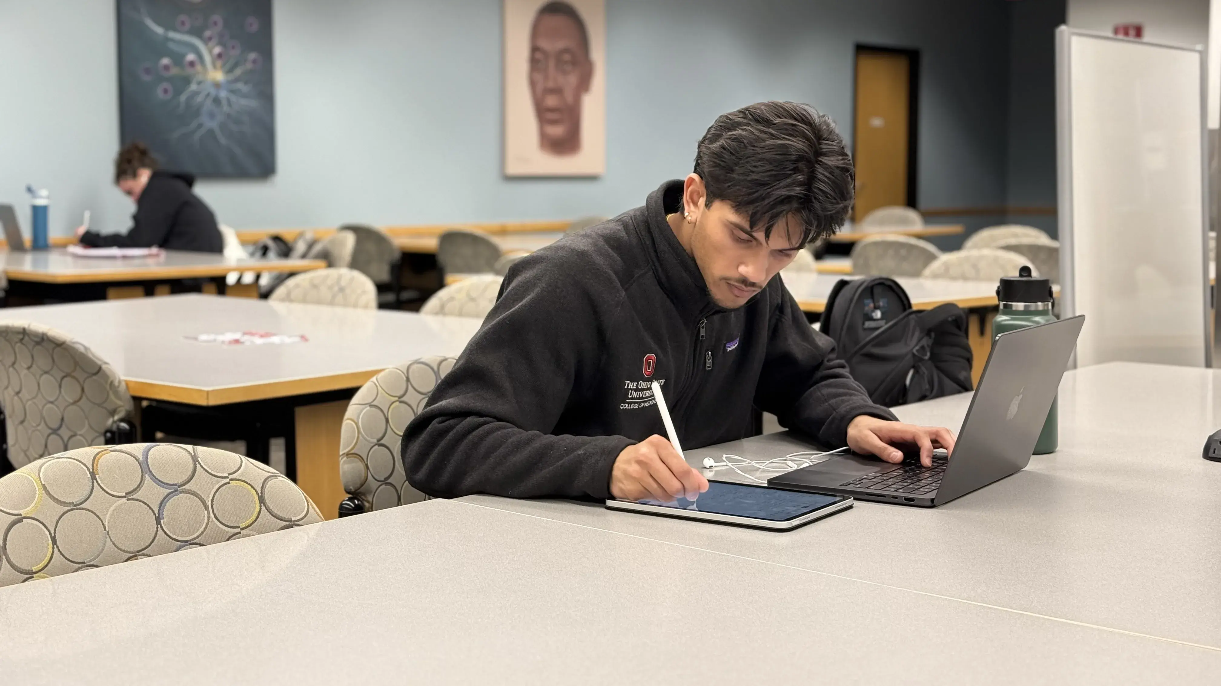 Student studying on the fourth floor of the Health Sciences Library.