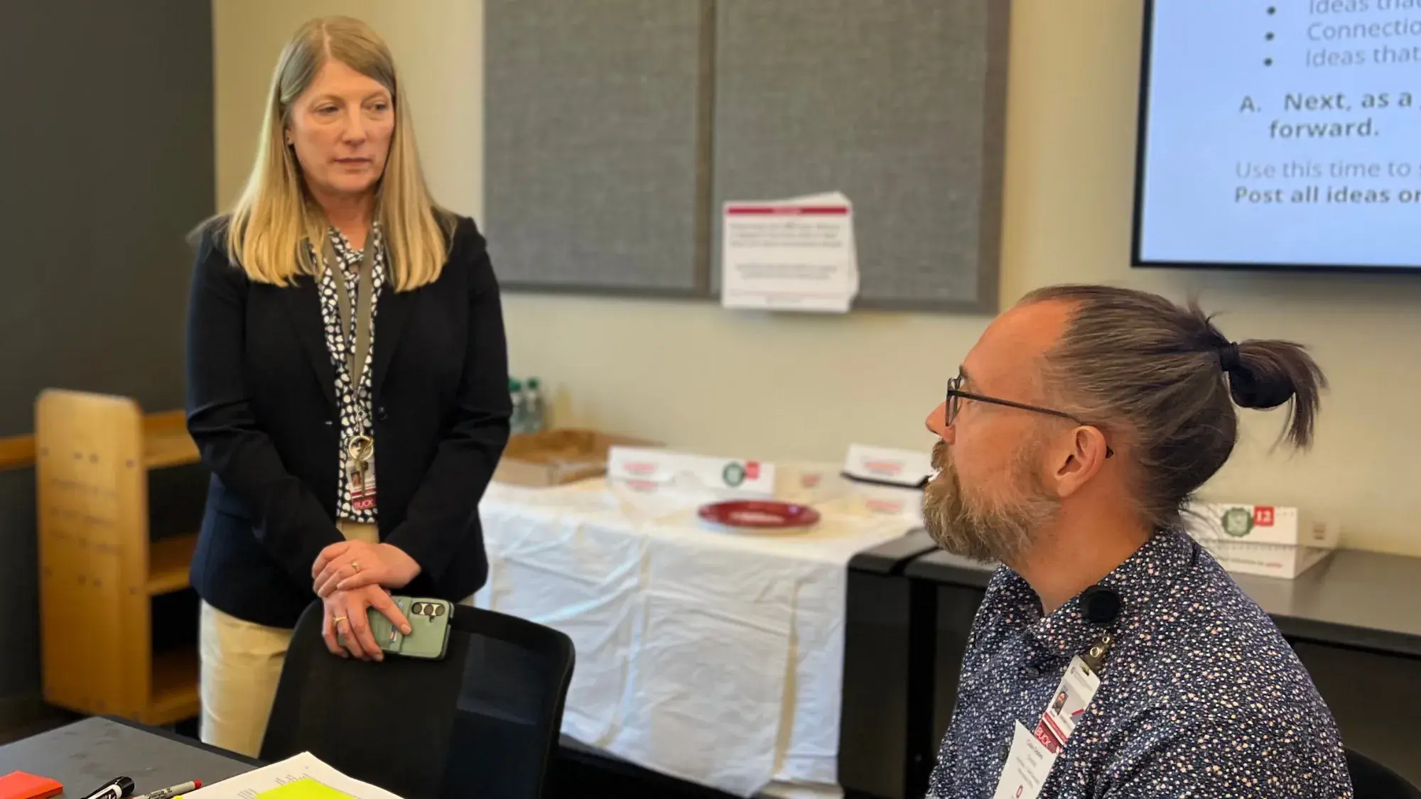 Stephanie Schulte listens to a participant in a meeting