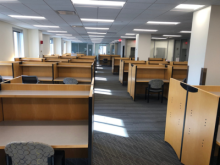 large room full of community desks with dividers
