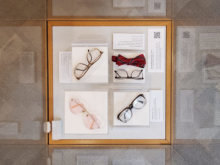 Four pairs of celebrity glasses in display case