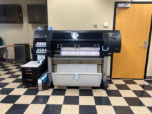 industrial printers sitting on a checkered floor