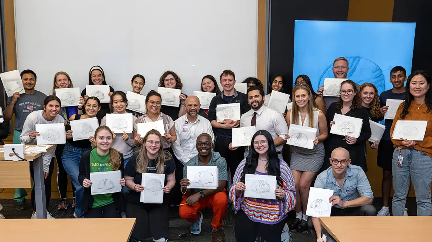 group of students share their drawings from the Draw a Brain workshop