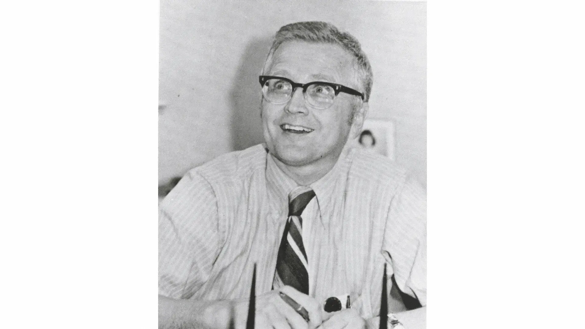 A candid moment of a young professional Ernest Johnson smiling