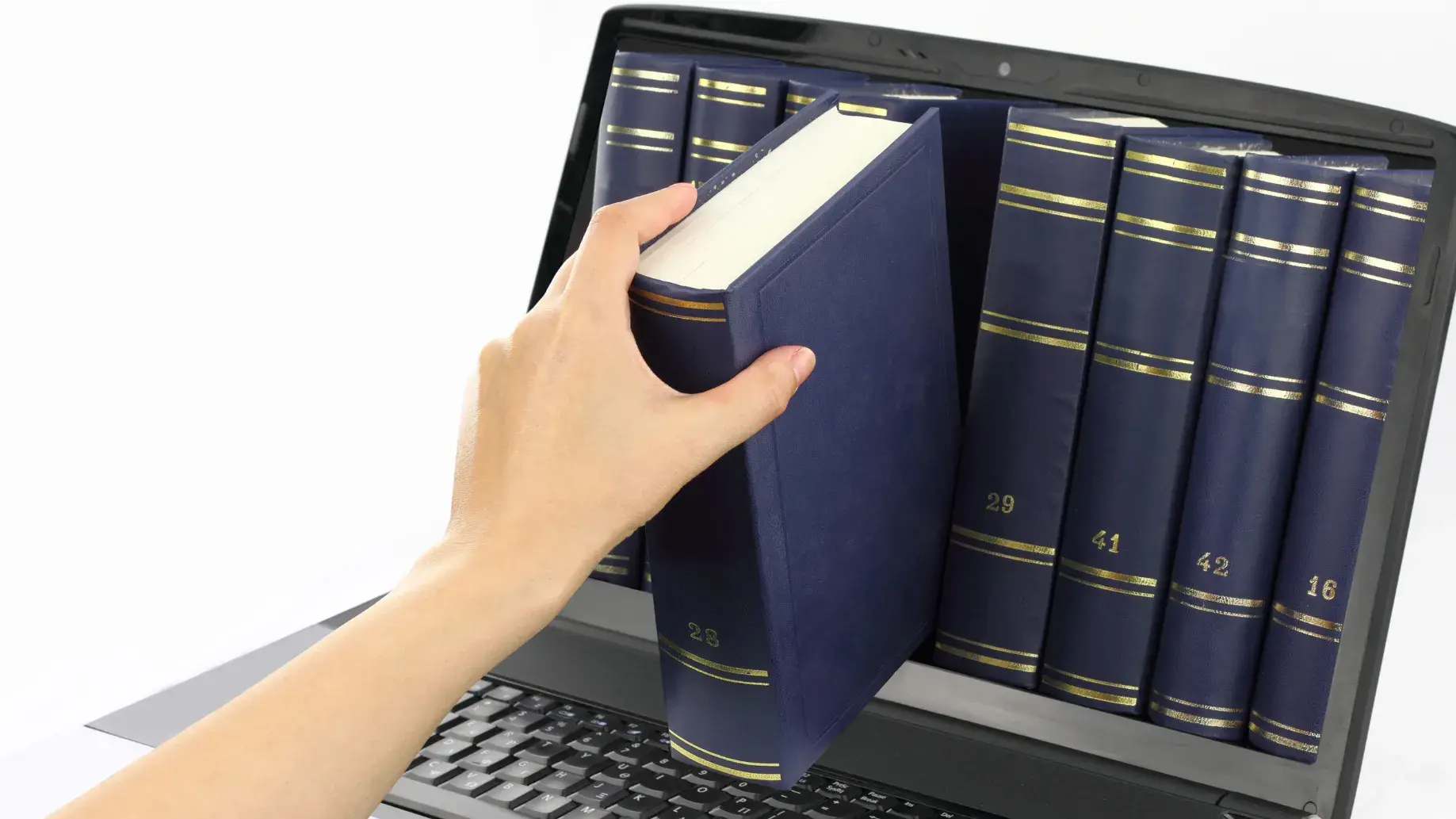 A hand retrieving a bound book out of a laptop screen, representing the use of electronic resources via a computer
