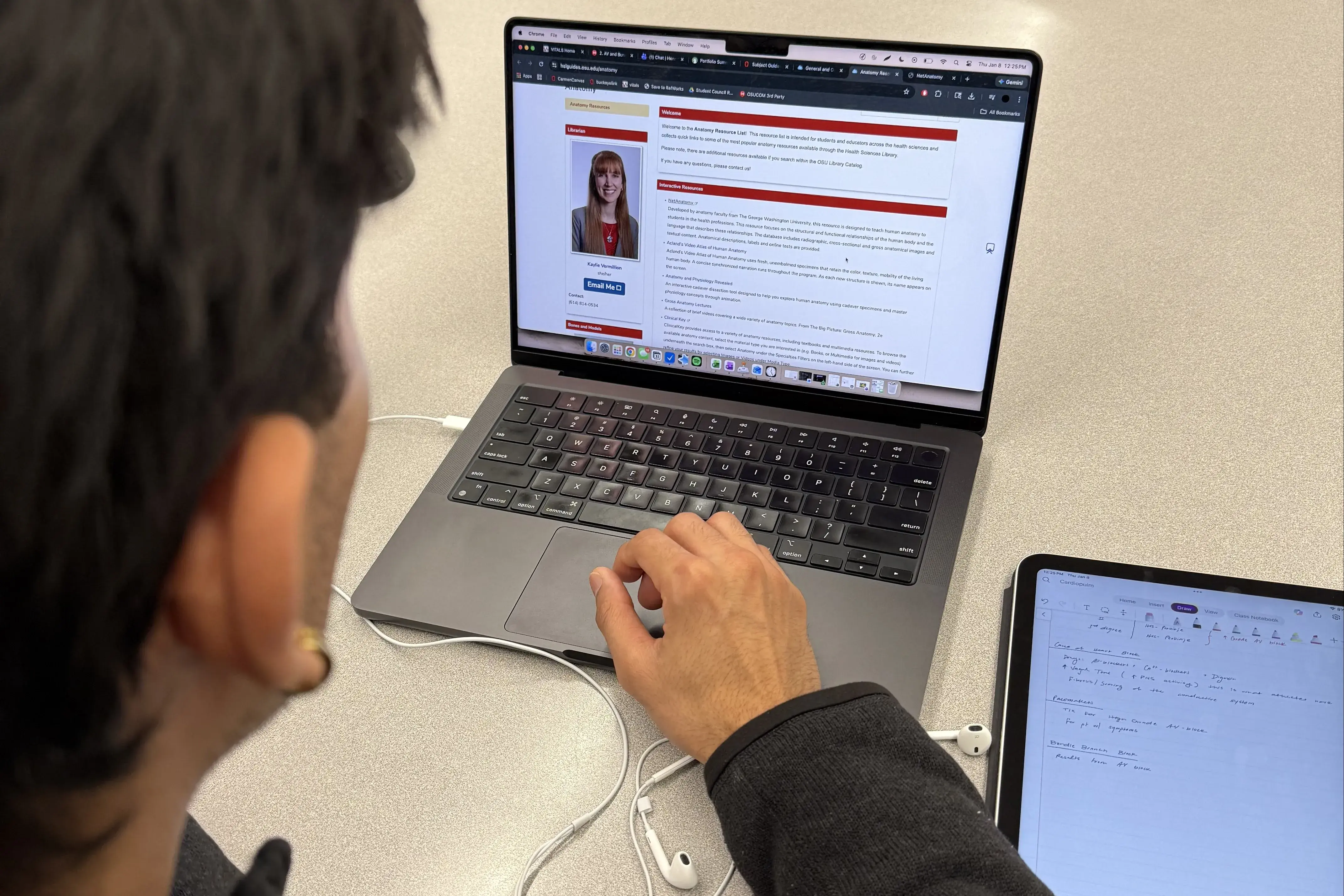 A student looks at an HSL subject guide on a laptop screen